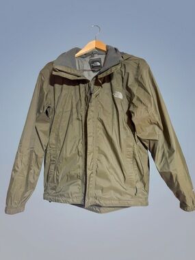 The North Face Olive Hooded Rain Shell Jacket accompanied with black NF Pants